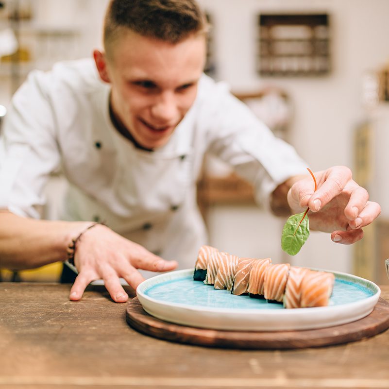 Man cooking Sushi rolls